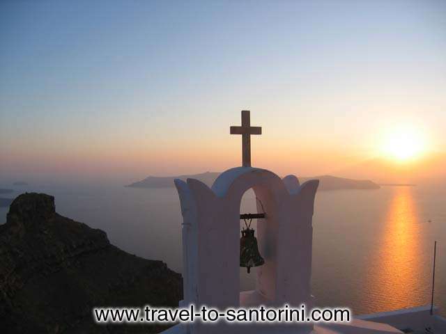 A sunset from Agio Pneyma church at Imerovigli. A great view of the Caldera in front of Skaros with sunset behind Thirassia and Oia.  