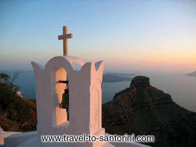 View of Skaros from Agio Pneyma church in Imerovigli during the sunset.<br>  In the background are visible Palea and Nea Kameni (the volcano) and Aspronissi. SANTORINI PHOTO GALLERY - SKAROS AT SUNSET by Ioannis Matrozos