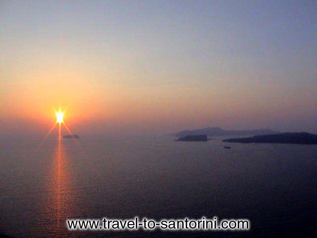 A sunset in Akrotiri with the sun behind Aspronissi. On the right Palea and Nea Kameni (volcano) and Thirassia. SANTORINI PHOTO GALLERY - AKROTIRI SUNSET