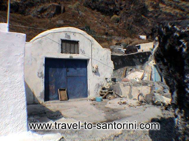 Curved house - A small caved house at the port of Thirassia, used for the fishing boats during the winter. by Alexandros Damigos