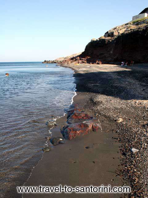 AFTERNOON - The beach of Pori in Santorini in the afternoon when the rocks above the beach offer their shadow