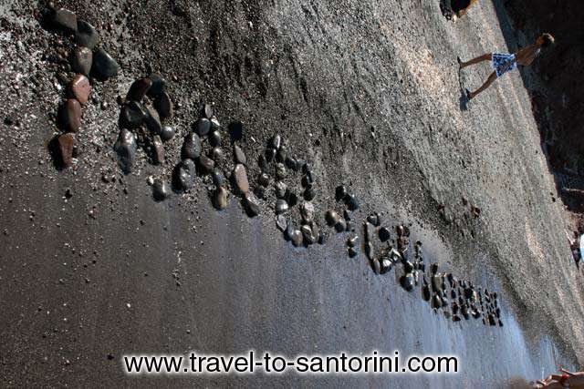 TRAVEL-TO-SANTORINI - Travel-to-Santorini writen with stones on the beach