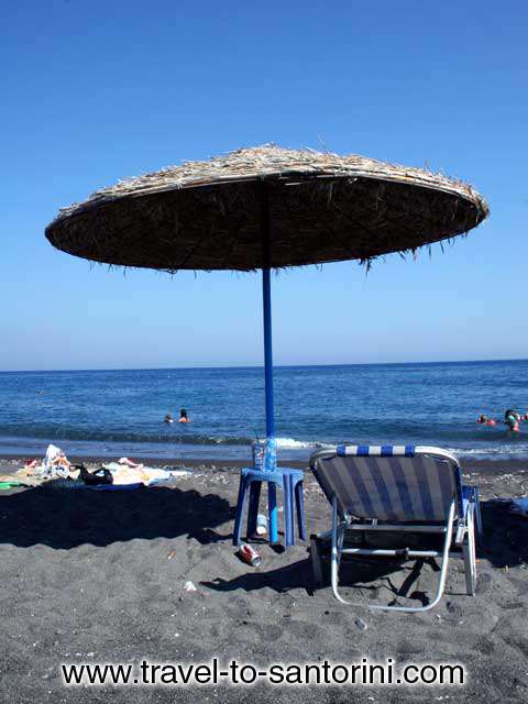 UMBRELLA - An umbrella offering shadow in Agios Georgios beach in Santorini