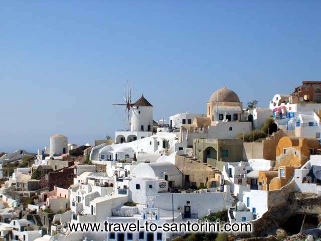 View of the northern part of Oia from the castle. This is the area just above Ammoudi.  The picture highlights the windmill that is the first recognisable b  