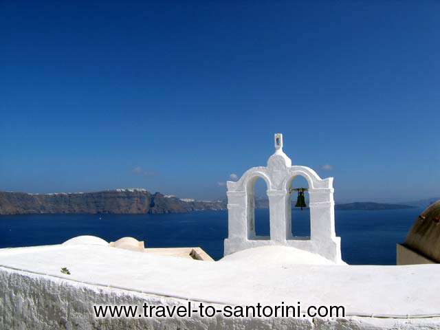 Church bell in Oia, Imerovigli and Kameni island (volcano) in the background. SANTORINI PHOTO GALLERY - OIA CHURCH BELL