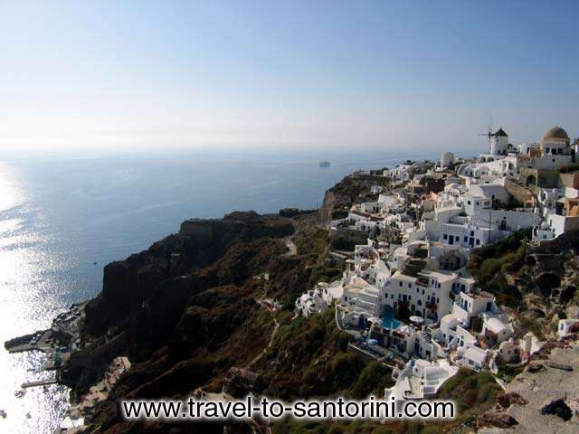 OIA WINDMILL - View of the last part of Oia at the northern edge of Santorini. It is the area after Oia castle. Here is located the stairway to Ammoudi. Also visible the famous windmill of Oia.