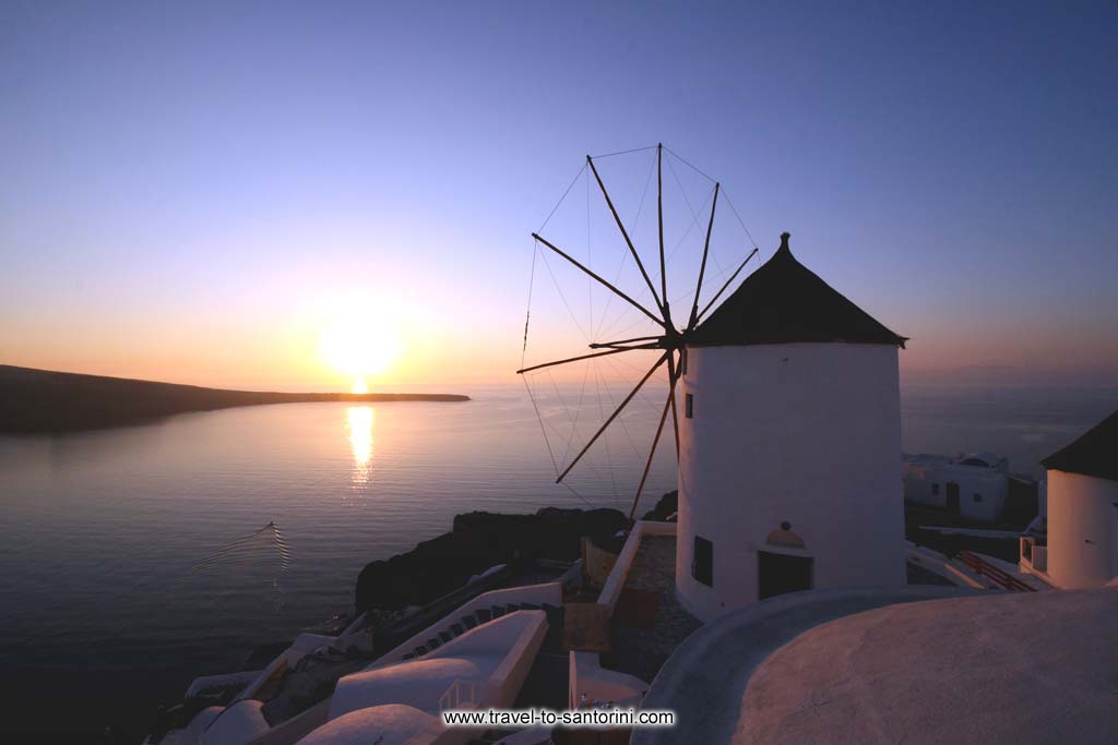 Golden Sunset Villas windmill - View of the famous windmill at the northern edge of Oia at sunset by Ioannis Matrozos