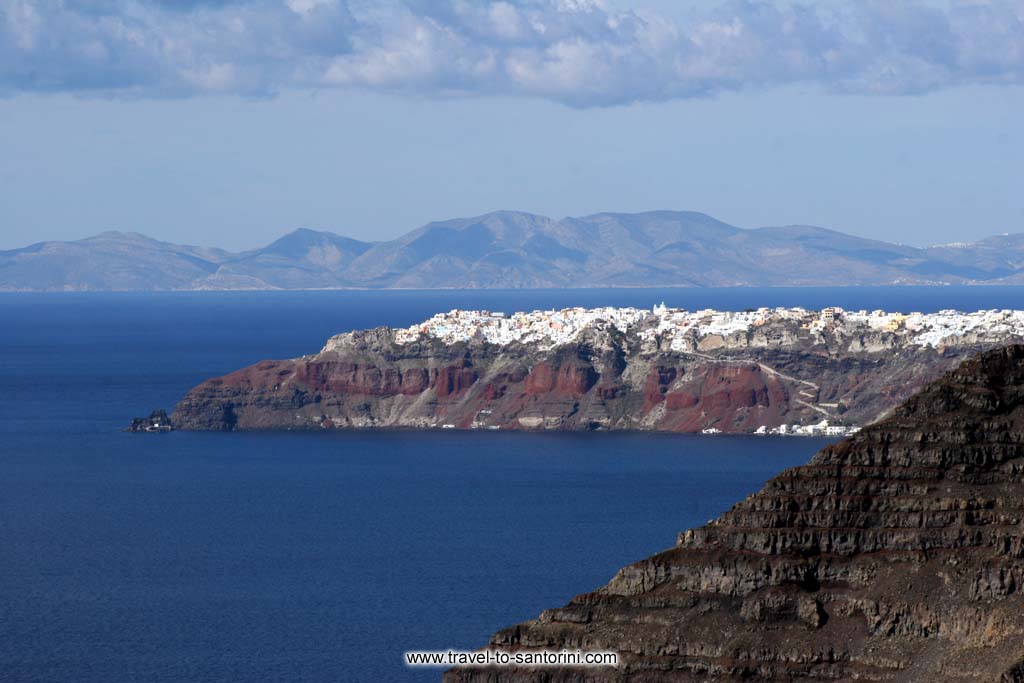 Skaros Oia Ios - When the weather is good (most times after a north wind) and the moisture low, one can see more than 10 islands around Santorini. In the picture (taken from Megalochori) Imerovigli (Skaros) Oia and Ios island are visible. by Ioannis Matrozos