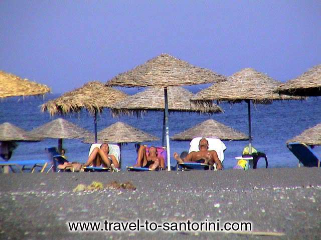 Sunbathing in Perissa! A company enjoying the sun early in the afternoon in Perissa.  