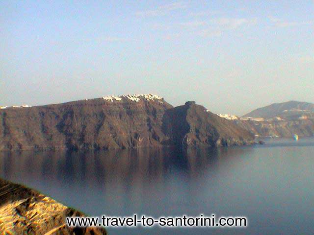 View of Imerovigli from Oia, Skaros rock in front of the village and<br> Theoskepasti (the small church in front of Skaros). SANTORINI PHOTO GALLERY - IMEROVIGLI