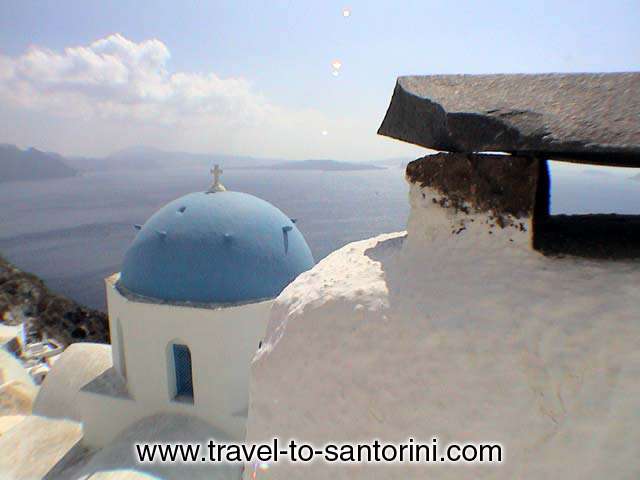 View of Anastasis church in Oia, a masterpiece of architecture.<br>
Visible in the background Skaros in front of Imerovigli and the volcano. SANTORINI PHOTO GALLERY - ANASTASIS CHURCH by Ioannis Matrozos