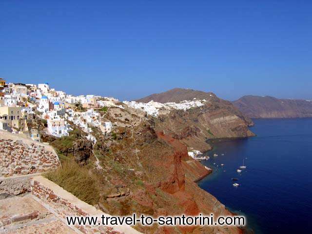 OIA CALDERA - View of Oia from within the castle. Visible Armeni and several fishing boats and yachts anchored, Perivolas area and the caldera on the way to Imerovigli