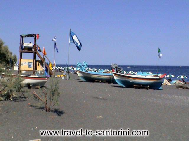 KAMARI BLUE FLAG - Boats and the blue flag at Kamari. The beach is being awarded the blue flag of clean seas for the last 10 years.