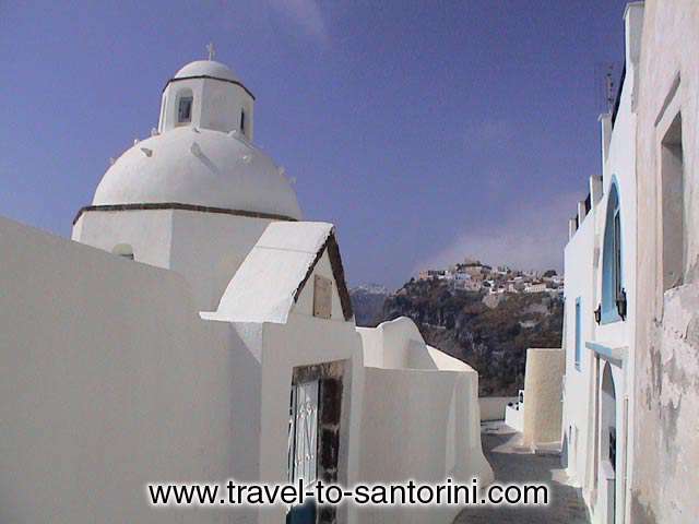 The church of Agios Minas in the narrow pathways at the edge of the Caldera. One of the most photographed churches in Santorini  